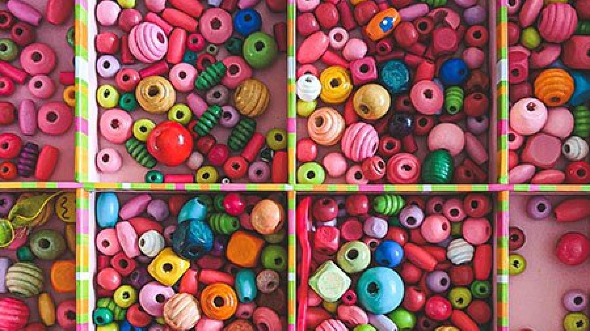 Assorted beads and materials in a tray